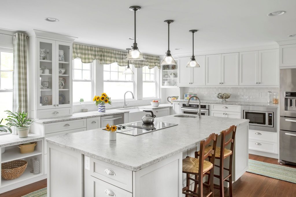 All white kitchen with wooden chairs