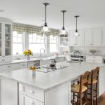 All white kitchen with wooden chairs