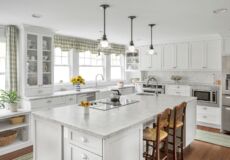 All white kitchen with wooden chairs